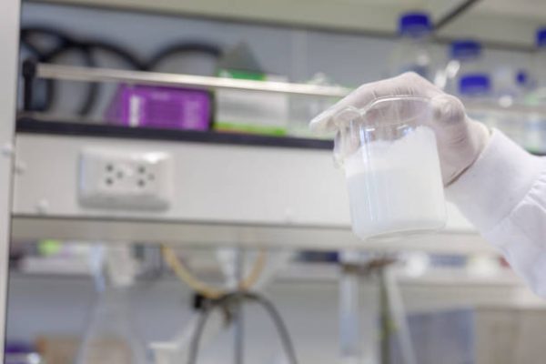 hand with white glove holding Concentrated latex